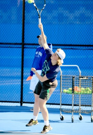 Grace Summers, a freshmen, practices a serve at the Darlings Courts Tues. March 31, 2015