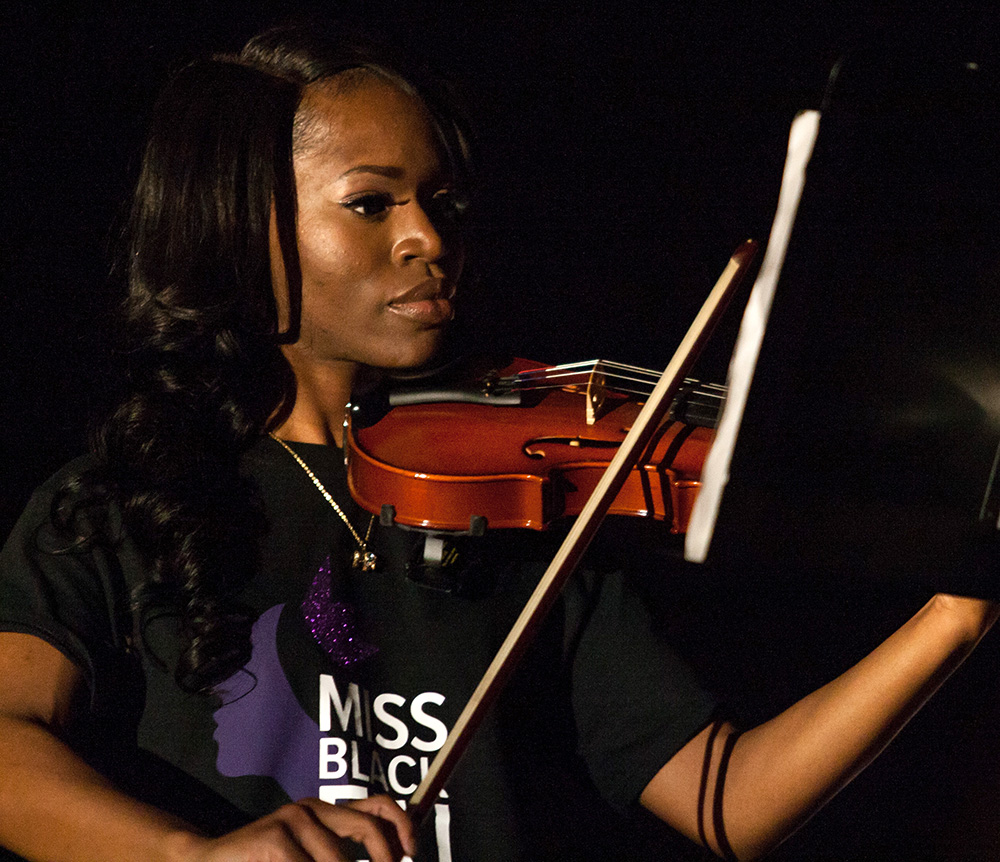 Senior Fudia Jalloh plays the violin during the talent section of the Miss Black EIU Scholarship Pageant Saturday, March 25.