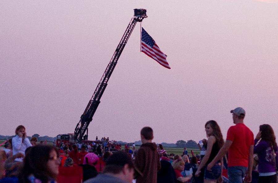 The Mattoon Fire Department displays a flag at the Coles County Airport July 4, 2013. Residents from Charleston, Mattoon and surrounding areas gathered for the fireworks show.