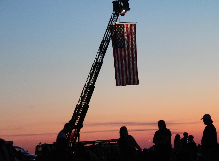 As part of Red, White and Blue Days, the Mattoon Fire Department displays the American flag before the fireworks show begins at the Coles County Airport Friday.