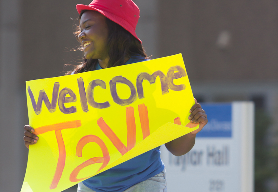 Ashley Howard, a senior psychology major and member of Delta Sigma Theta sorority, helps  students in the Gateway Program move into Taylor Hall on Tuesday.  The Gateway Program is an admissions program for students who do not meet the regular admissions requirements.  Mark Hudson, director of university housing & dining services, said that about 1,000 students will be moved in early once the residence halls officially open.  Hudson also noted changes that returning students can expect, such as new bathrooms in Ford Hall, new water bottle filling stations in Tower Dining in Stevenson Hall and Resident Select, a free service streaming movie service.