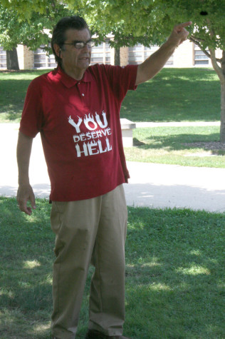 Brother Jed, an evangelistic Christian minister, talks to passing students on the Library Quad Tuesday.