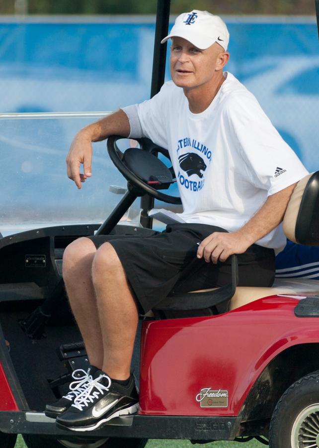Greg Stevens, offensive coordinator, watches practice Tuesday from a golf cart. 