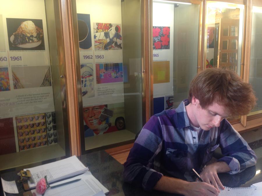 Matthew Reid, a senior math major, works on math homework in front of one of the many 60s displays in Booth Library. These displays, scattered across the library, will be part of a semester-long exhibit called Revolutionary Decade: Reflections on the 1960s.