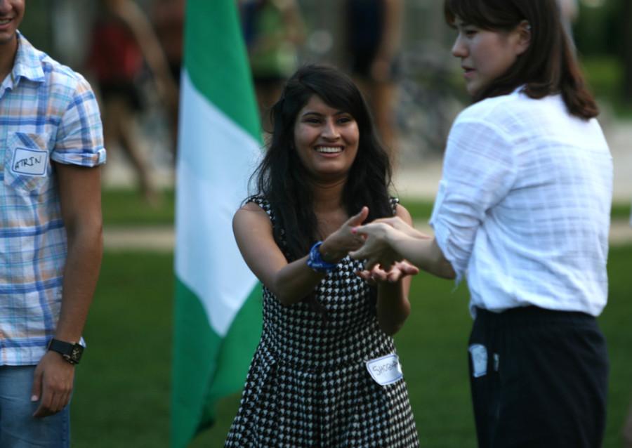 Shova Subedi, a freshman pre-nursing major, and MinJi Cha, a junior communications studies major, play a water balloon toss game during the International Student Welcome Sept. 5 on the South Quad.