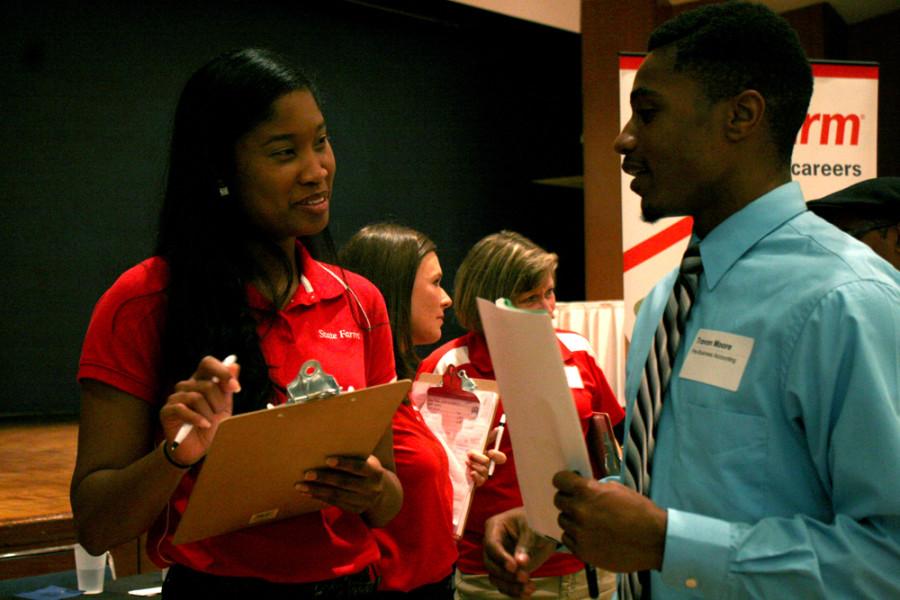 File Photo by Chynna Miller| The Daily Eastern News        
Travon Moore, a junior business major, meets with a State Farm Insurance representative at the Career Fair on September 25, 2013.