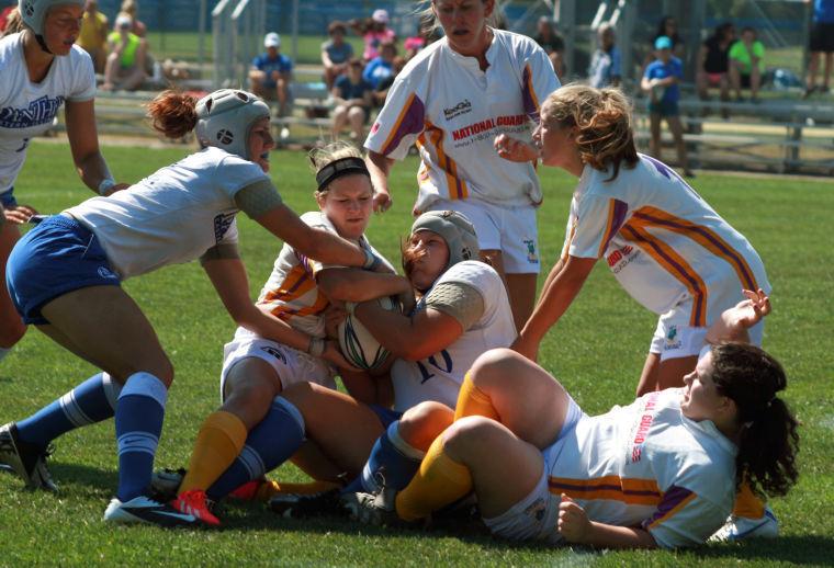 Rugby players wrestle one another to the ground to gain possession of the ball during a game against the Wisconsin All-Stars on Sept. 9 , 2013 at Lakeside Field.