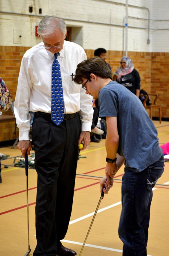 President William Perry and Bradly Ogilvie, a junior mathematics and comupter science major, play putt putt golf during Putt Putt with the Prez Tuesday in McAfee Gymnasium.