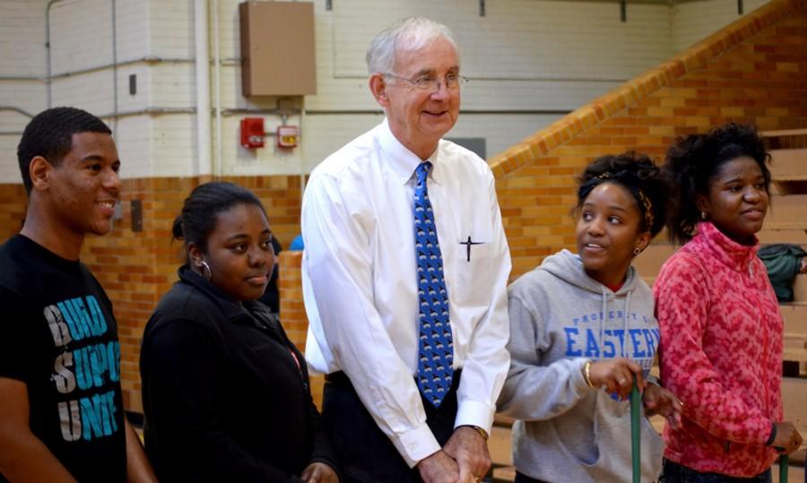 President Bill Perry poses for photos with a group of friends during Putt Putt with the Prez Tuesday in McAfee Gymnasium.