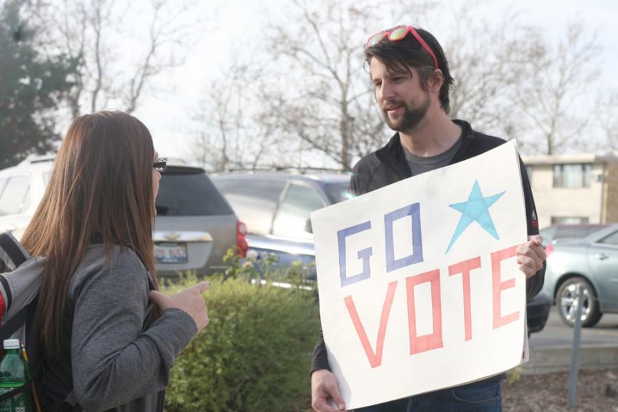 Chynna Miller| The Daily Eastern News                                 
Ryan Woods, a senior political science major and the President of EIU College Democrats, conversates with Stephanie Garcia, a senior politcal science major, about voting Monday in the library quad.