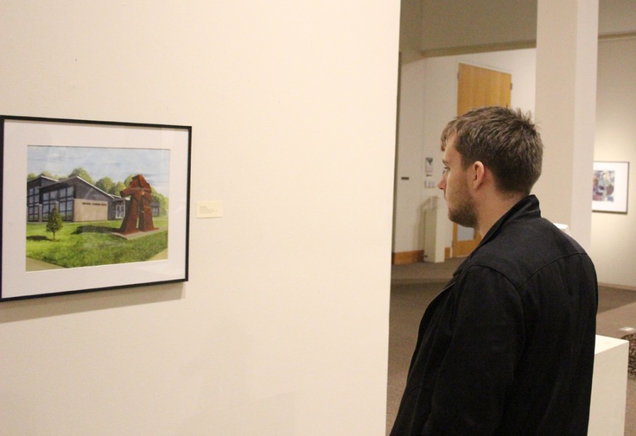 Ryan Birmingham, a freshmen political science major, looks at art by Jan Kappes at the machines that make exhibit Tuesday in the Tarble Art Center