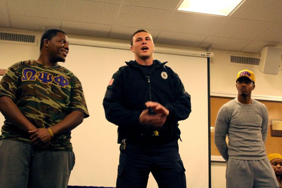 Chynna Miller | The Daily Eastern News      
Officer Chase Sanford, an officer in the University Police Department, discusses party protocols and policies during the Omega Psi Phi Fraternity Inc., Founders Day Mocktail police interaction forum Monday in the basement of Taylor Hall.
