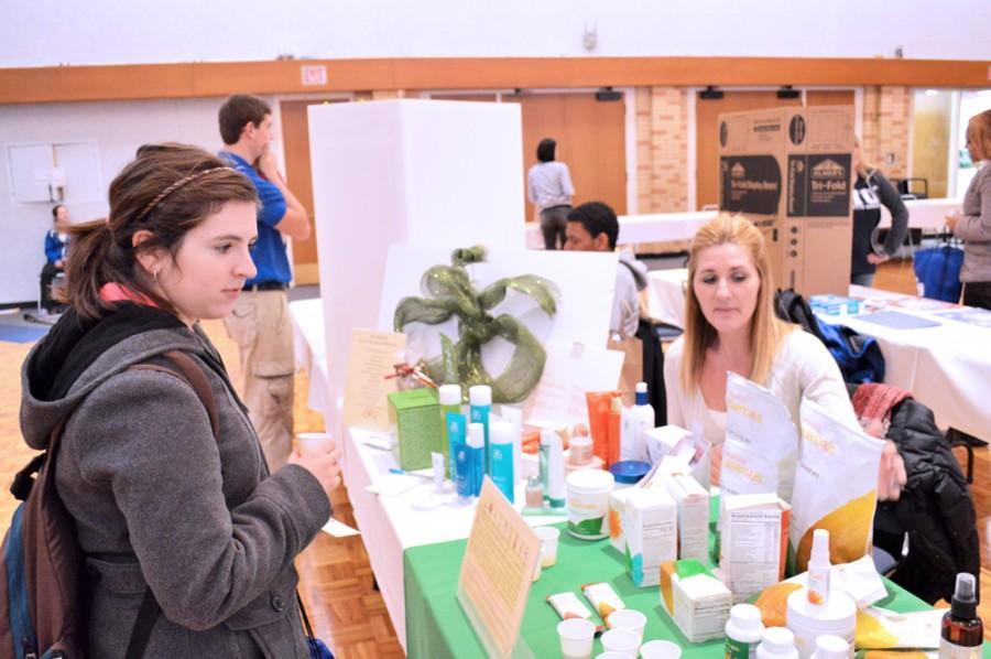 Russell Siler | The Daily Eastern News
Rebecca Williamson, a senior early childhood education major, looks through samples of Arbonne, a toxin-free health and wellness products, with Jessica Willcut, Arbonne Area Manager, at The Price is Right Health Fair Wednesday in the Grand Ballroom of the Martin Luther King Jr., University Union.
