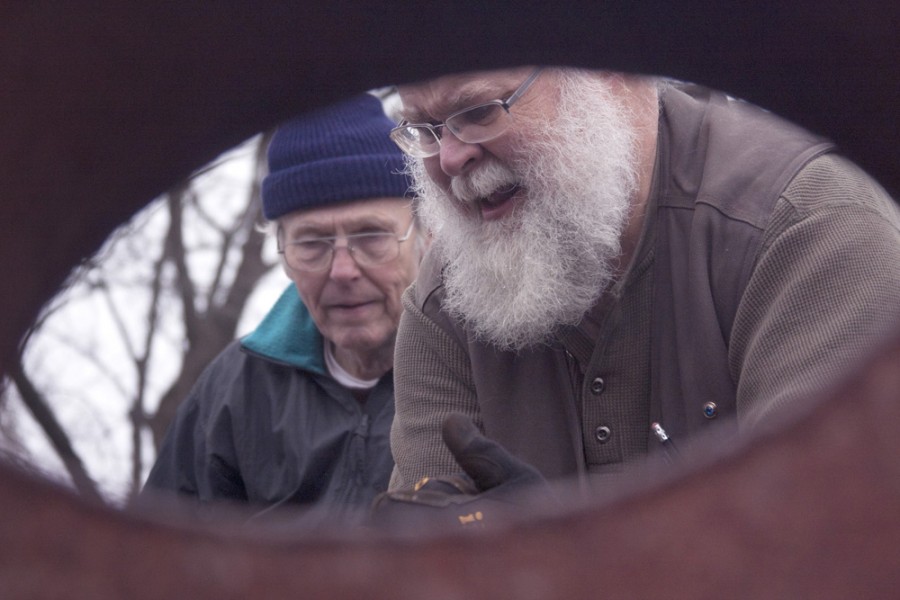 Retired art professor Jeff Boshart and Retired Dean James Johnson strap down a sculpture to a trailer Dec. 4, 2014 outside of Doudna Fine Arts Center. Boshart and Johnson both have works featured in the current Above and Beyond 3-D art exhibit in the Tarble Arts Center.