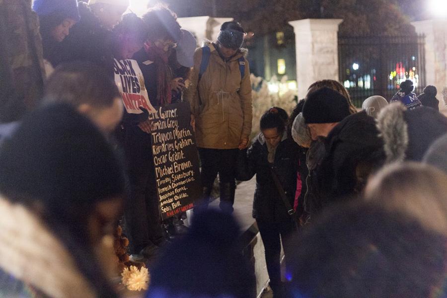 Students pray outside the gates at Old Main on Tuesday.  The event, sponsored by the Performing Arts for Effective Civic Education student organization, was a solidarity march from Carmen Hall to Old Main for the events in Ferguson, Mo.