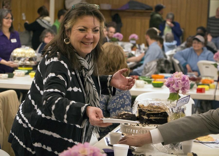 Mary Bower passes out double chocolate cake with caramel cream to friends at the Bowls of HOPE fundraiser Feb.17 at the St. Charles Borromeo Church. The Bowls of Fun event this Monday will contribute to the next Bowls of HOPE in early 2016.