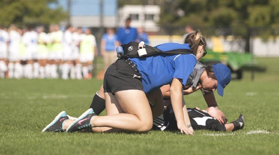 An+Eastern+athletic+trainer+and+student+trainer+check+red-shirt+sophomore+goalkeeper+Kylie+Morgan+after+she+collided+with+a+Valparaiso+opponent+during+a+game+on+Sept.+19+at+Lakeside+Field.++Morgan+was+taken+off+the+field+and+did+not+return+to+the+game.