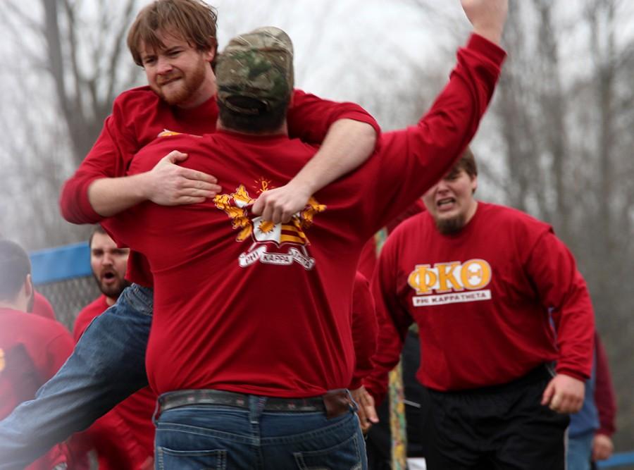 John Hopkins, a senior English major and a coach for Phi Kappa Theta, jumps into the arms of another coach after the Phi Kaps win against Pi Kappa Alpha during the Tugs competition Monday at the Campus Pond.