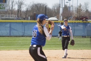 Freshman infielder Katie Watson passes the ball to Sophomore pitcher Hannah Rachor during the Eastern women’s softball game on April 4, 2015.
