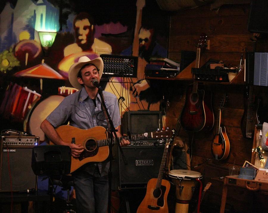 Adam Klein, of “Adam Klein and The Wild Fires performs the West Virginia coal miner song “Black Lung Blues” Wednesday night on the Square at Jackson Avenue Coffee. The band is based out of Atlanta,GA by way of Athens, GA.