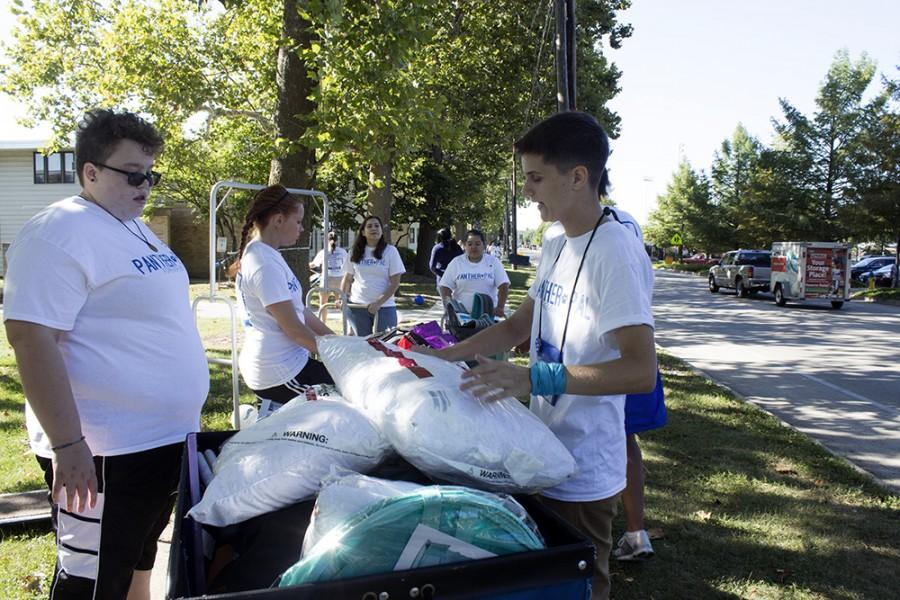 Riley Snyder, a junior art major and Panther Pal, loads incoming students’ belongings into a bin for Move-In Day outside of Ford Hall. Panther Pals awaited incoming students and their parents outside every residence hall to assist with moving in.