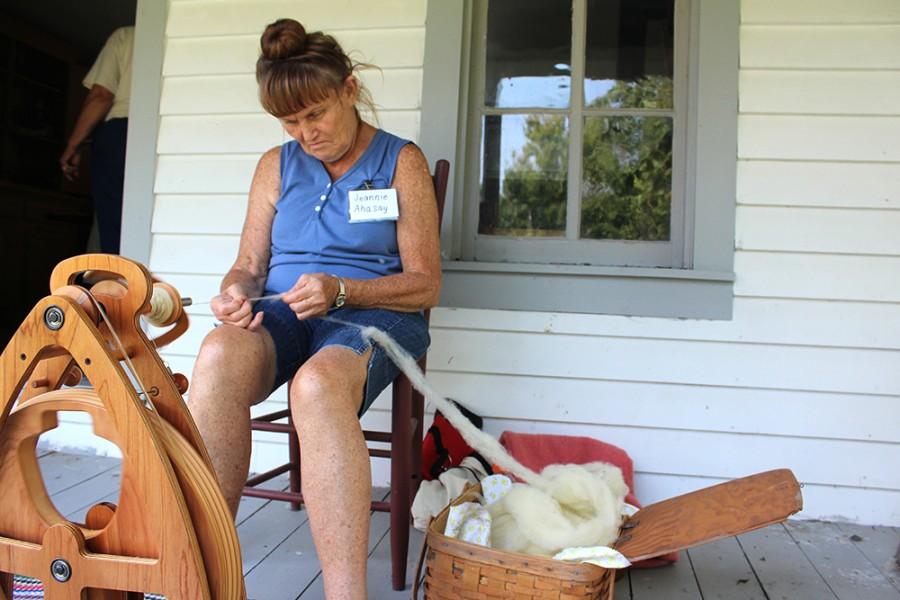 Jeannie Ahasay, a volunteer at the Five Mile House, demonstrates how women in pioneer times would spin yarn out of sheeps fleece on Aug. 30. Ahasay said it would probably take about three to five hours to spin one spindle of yarn if she sat down and just did that.