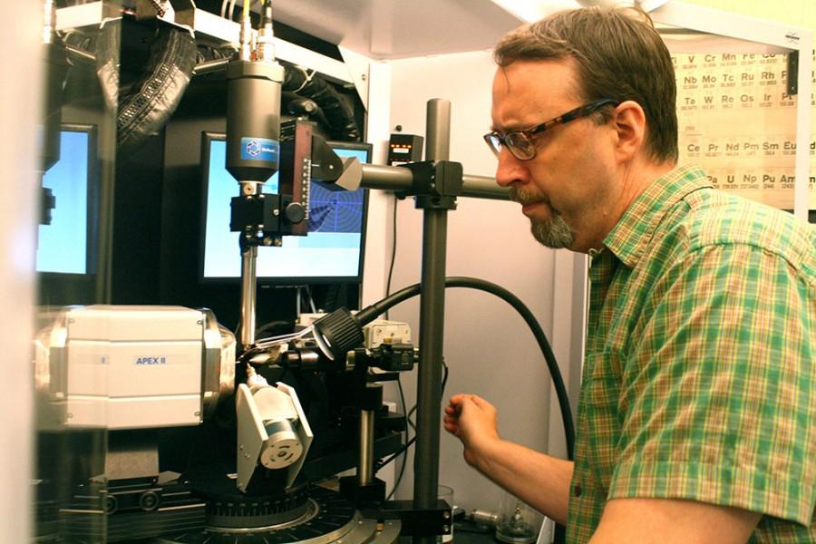 Dr. Kraig Wheeler, a professor of chemistry  demonstrates an X-Ray machine in a chemistry lab in the physical science building on Thursday. The machine exposes crystals to X-Rays to determine molecular structure and crystal structure.