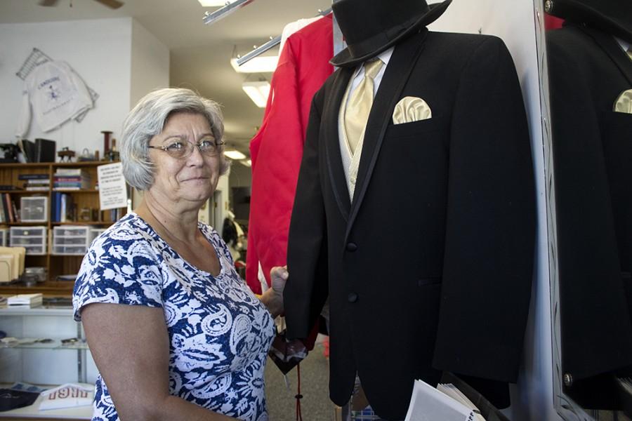 Kathy Jenkins, owner ofthe Sewing Salon off the square, poses with a mannequin that displays one of the tuxedos she rents.