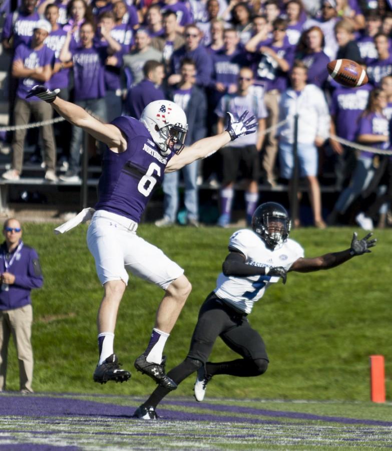 Northwesterns Mike McHugh and red-shirt senior defensive back Antoine Johnson leap for the ball during Easterns 41-0 loss to Northwestern on Saturday at Ryan Field in Evanston, Ill.