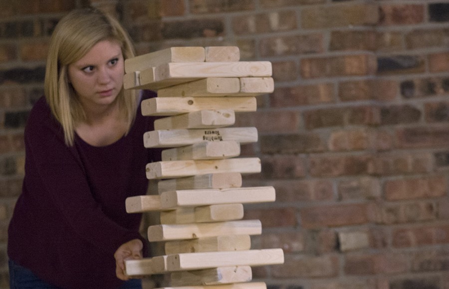 Fallon Kitchens, a freshman undecided major, watches as the life-size Jinga blocks wabble during the third day of ROC Fest in 7th Street Underground on Wednesday.