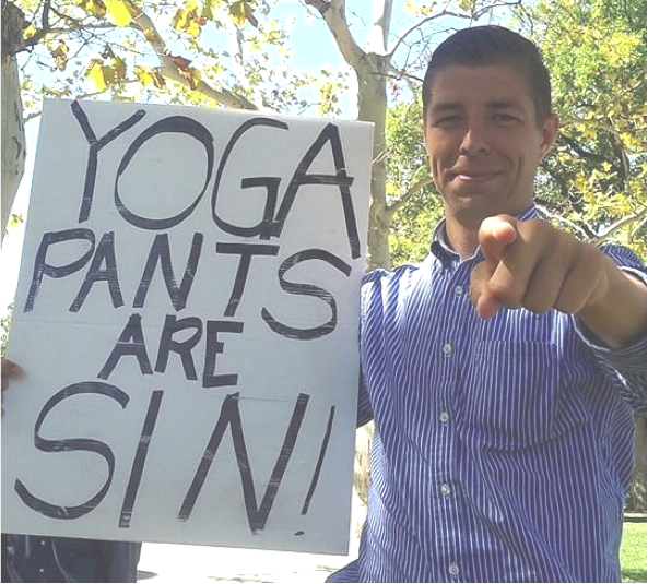 Photo by Stephanie White | The Daily Eastern News
Brother Mikhail Sovenko holds up a sign stating Yoga pants are sin Monday afternoon in front of the Booth Library. Sovenko and his mentor Brother Jed have visited Eastern numerous times and within the past week have preached to passing by students near Booth and the steps near the Doudna Fine Arts Center.