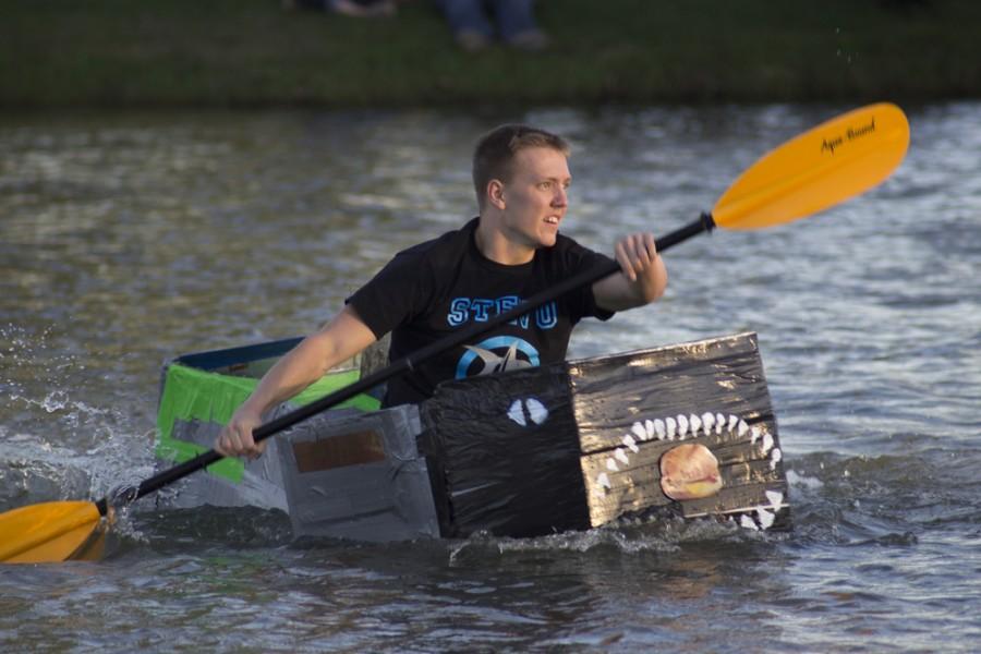 Drew King, a sophomore kinesiology and sports studies major, rows the Stevenson Hall boat to victory during the final lap of the Boat Races Thursday at Campus Pond. The races are a part of RHA’s ROC Fest Week.