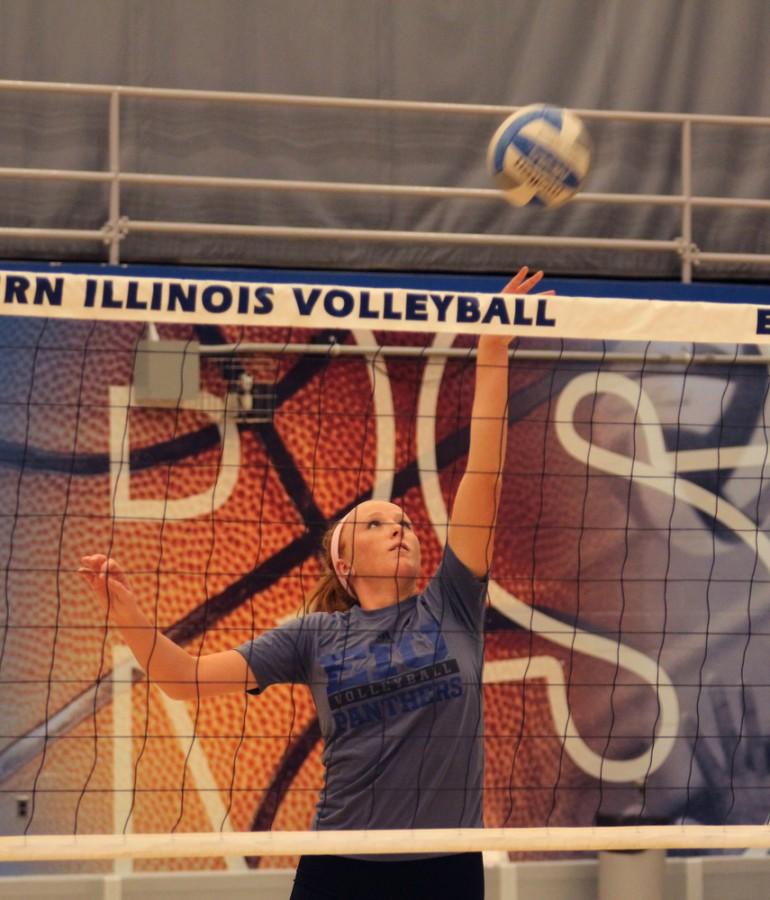 Sophomore middle hitter Allie Hueston tips the ball over the net during practice Tuesday in Lantz Arena.