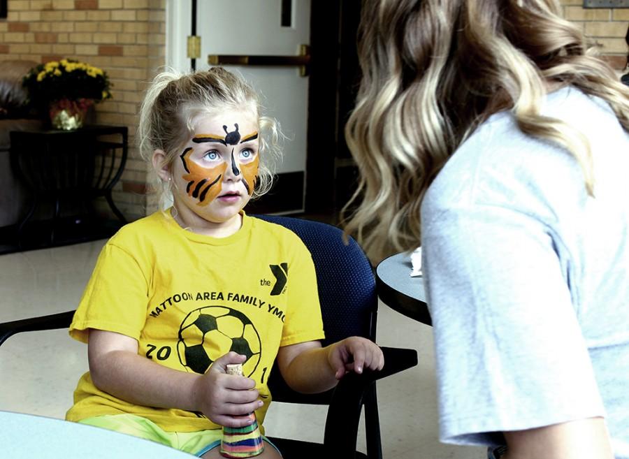 Kelsey Trigg, a Charleston resident, gets her face painted at the Face Painting/Sand Art Bottle event on Sept. 20, 2014 at the Bridge Lounge in Martin Luther King Jr. University Union.