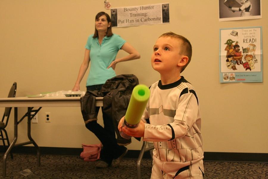 Owen Keefe, a 5-year-old Charleston resident, gets ready to hit a red balloon with his pool noodle light saber at the Star Wars Reads day event put on at the Charleston Carnegie Public Library Wednesday.