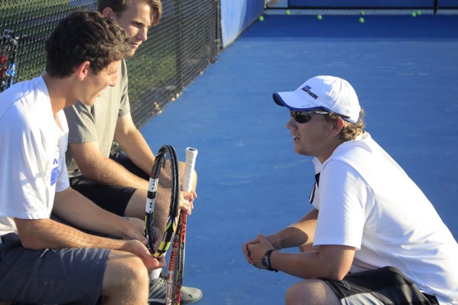 Men's tennis coach, Sam Kercheval speaks with senior players Rui Silva (left) and Ryan Henderson (right) during practice last Wednesday at Darling Courts.