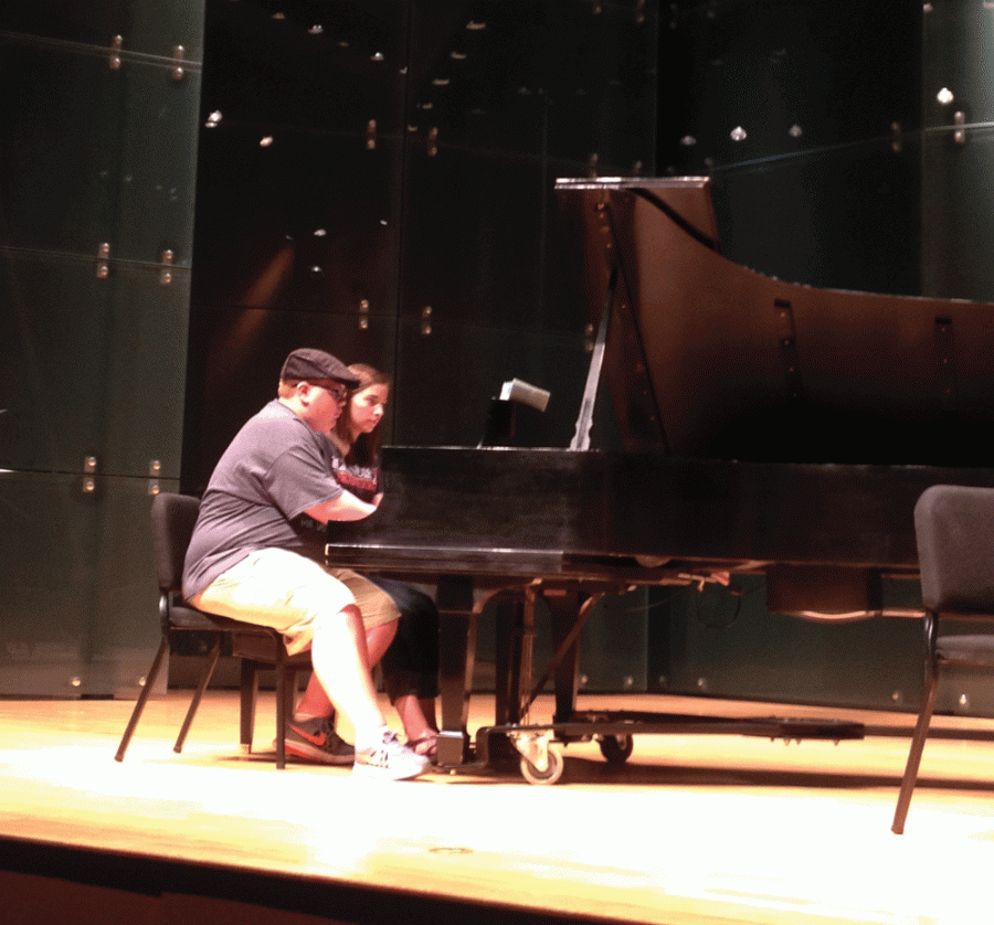 Two competitors practice their respective pieces for the Midwest Collabrative Piano Competition. The competition takes place on Saturday in the recital hall of the Doudna Fine Arts Center.