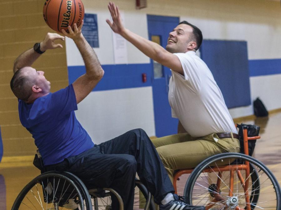 Second Lieutenant and recruiter for the ROTC Panther Battalion Cody Gallagher guards Cpt. Daniel Alix, assistant professor of millitary science, on Saturday during a game of wheelchair basketball in the Student Recreation Center. This activity was created to show students and community members the hardships faced by disabled veterans.