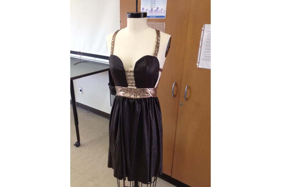 A+mini+mannequin+is+used+by+a+student+first+before+replicating+it+on+a+much+larger+mannequin.