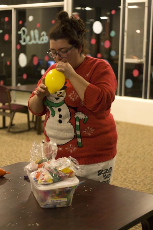 Valerie Ponce, a freshman communication studies major and recognition chair for Andrews Hall Council, makes a stress ball after the meeting in Andrews Hall Lobby Wednesday. Ponce said making the stress balls made her feel less stressed.