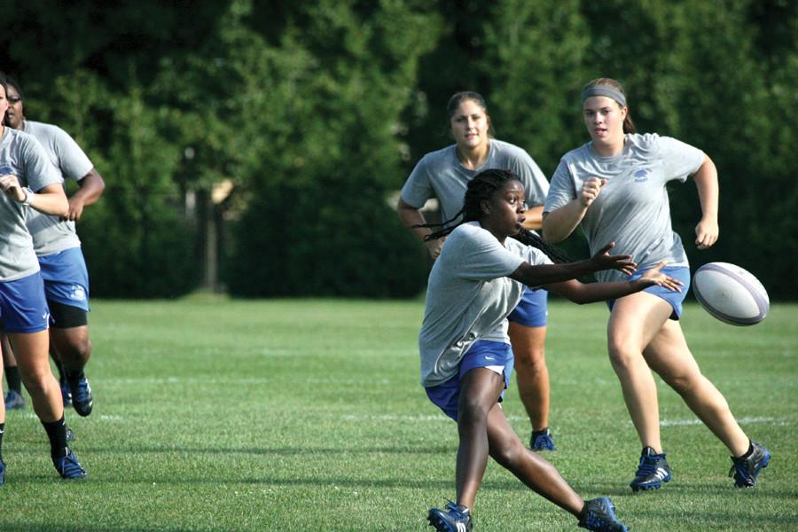 Junior wing Jasmine Gardner dives for the ball at Rugby practice September 3, 2014.