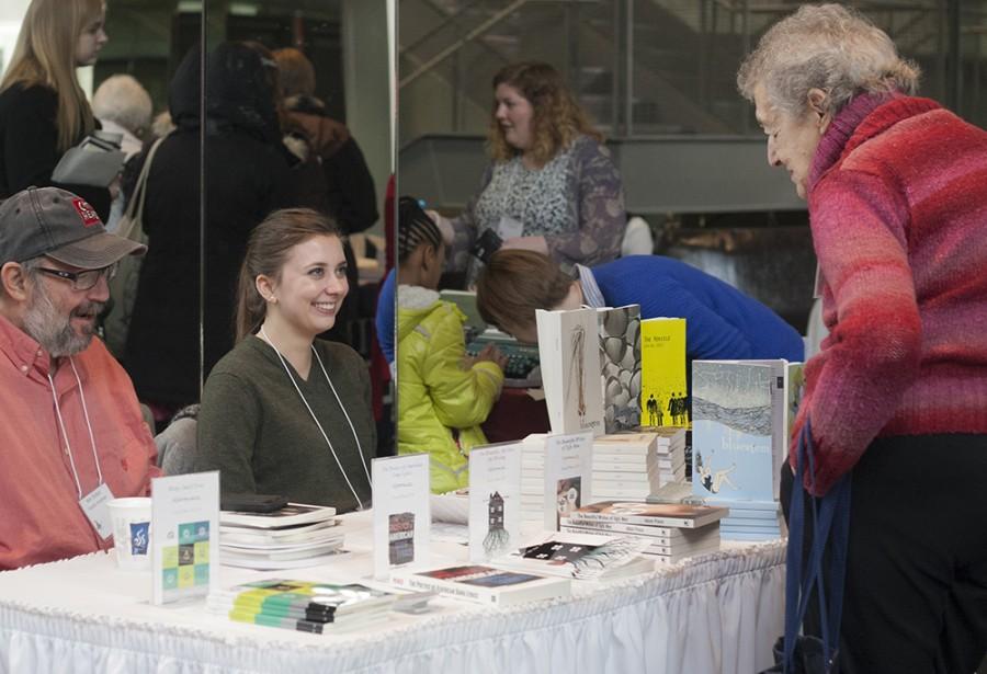 People look at and sell books during a book fair at the Lions in Winter Literary Festival Saturday afternoon in Doudna Fine Arts Center.