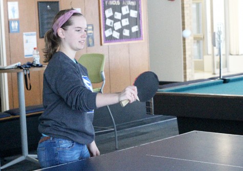 Ava Gillespie, a freshman history and English major, plays ping pong in the Thomas Hall lobby during the snow day Wednesday.