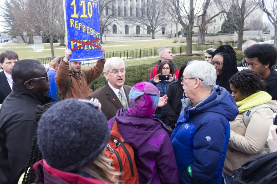 Rep. Reggie Phillips, R-Charleston, talks with constituents as budget concerns force students to descend on the capitol steps of the Illinois State house to rally for higher education funding on Feb. 17 in Springfield.