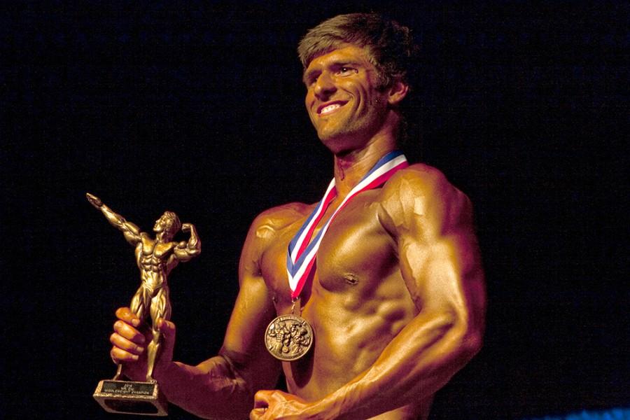 Kody Waggoner, a competitor in the middle weight division, accepts the trophy for his weight class, Mar. 1, 2014 in the McAffee Gym. The judges  shortly revoked his title, after a miscount of votes determined Waggoner the winner of his division. The revoking of his title prevented Waggoner from moving on in the competition and competing for the title of Mr. EIU.