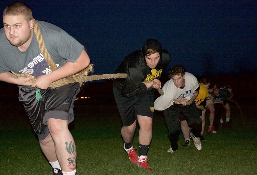 Members of Phi Kappa Theta practice for Tugs at the Sigma Kappa Field near Textbook Rental on Thursday.