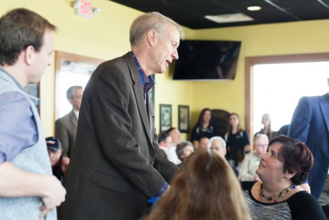 Gov. Bruce Rauner talks to Erin Walters, executive director of the Sexual Assault Counseling Information Service, during an endorsement stop for U.S. Rep. John Shimkus at the Stadium Bar & Grill in Mattoon. Walters asked Rauner about funding for rape crisis centers. Rauner briefly touched on funding for Eastern and higher education before introducing Shimkus.