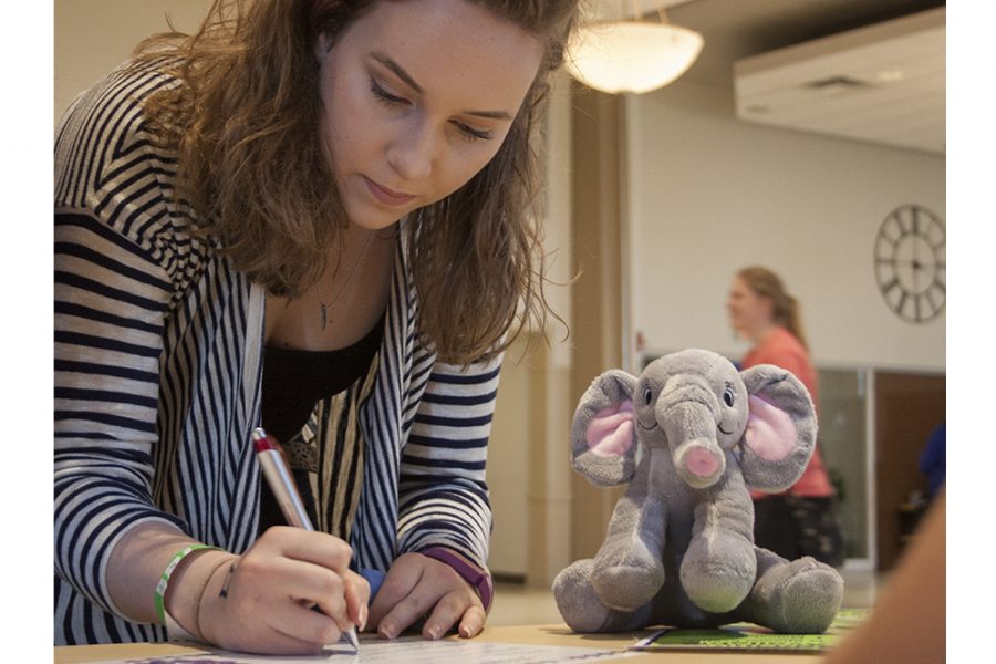 Kelsea Higgins, a freshman accounting major, fills out an adoption certificate for the stuff-a-bear she made Thursday in the University Ballroom during Pantherstock. 