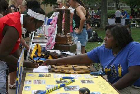 File Photo | The Daily Eastern News Regime Billingsly, a junior athletic training major, explains the sign up sheet for Sigma Gamma Rho Sorority, Inc. to Sarah Ampadu, a senior health studies major, at Panther Palooza on August 27, 2015.