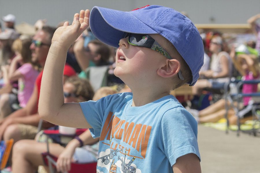 Rowan Faust, a 4-year-old from Philo, Illinois, waves at Wingman Teresa Stokes as she flies past him and his family during the air show at the Coles County Memorial Airport Saturday.